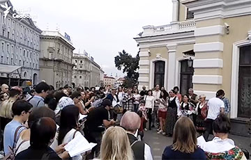 Сотни человек пришли под Купаловский театр и поют патриотические песни
